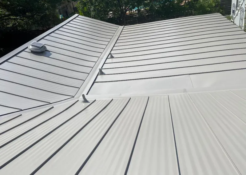 Solar attic fan installed on a metal roof for Roof Ventilation in Gallup